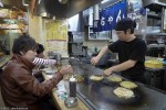 Serving Hiroshima-style Okonomiyaki, Okonomi-mura,&nbsp;Hiroshima