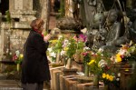 Woman making offering to Jizō Statues, Oku-no-in Cemetery,&nbsp;Koya